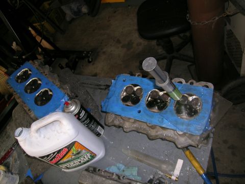 1995 Ford Probe - Engine components are laid out on a workbench with tools and cleaning supplies.