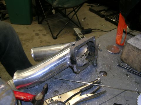 1995 Ford Probe - Custom exhaust pipe fabrication in progress, showing a flange and various tools.