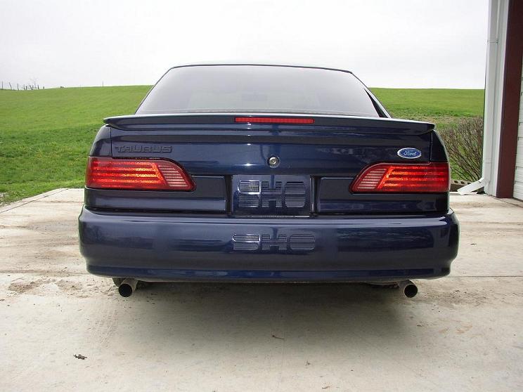 Dark blue 1993 Ford Taurus SHO sedan rear view with spoiler and dual exhaust pipes