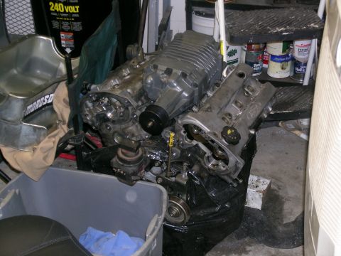 1995 Ford Probe - Engine assembly with a prominent supercharger sits in a garage, possibly for a custom build.