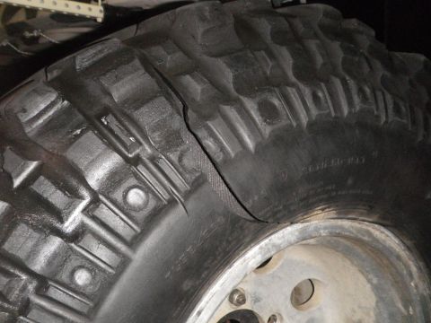 1991 Ford Bronco - A damaged tire shows a significant bulge, indicating a potential failure.