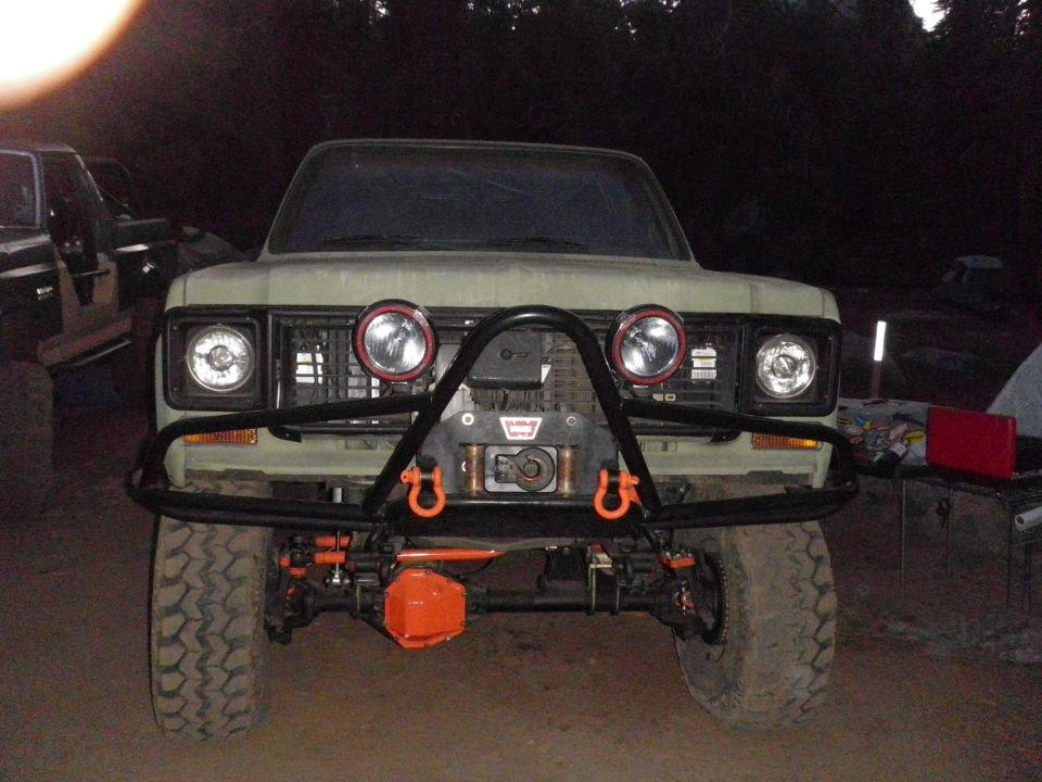 Olive green Ford Bronco with winch and off-road lights, front view