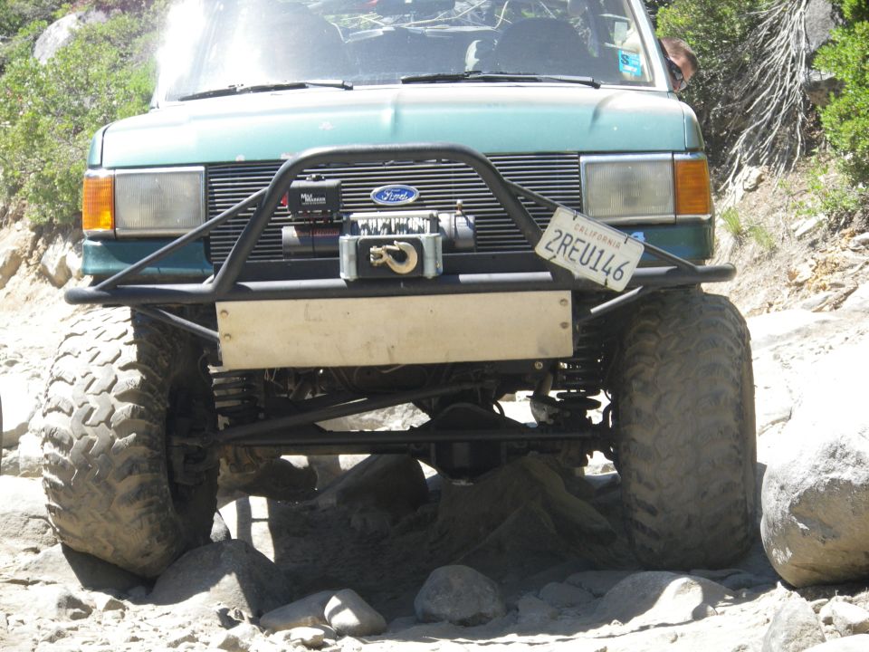 Front view of green off-road vehicle with winch and California license plate 2REU146