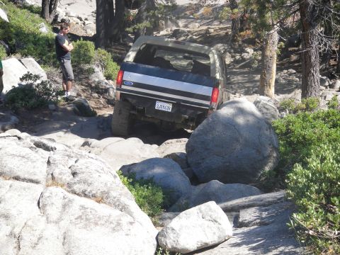 1991 Ford Bronco - A 1991 Ford Bronco tackles a challenging rocky path, demonstrating its off-road capabilities.
