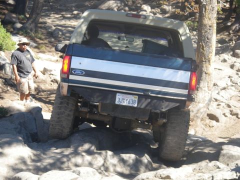 1991 Ford Bronco - A Ford Bronco navigates a challenging rocky trail.
