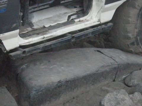 1991 Ford Bronco - Side view of a 1991 Ford Bronco's door and running board, positioned on rocks.