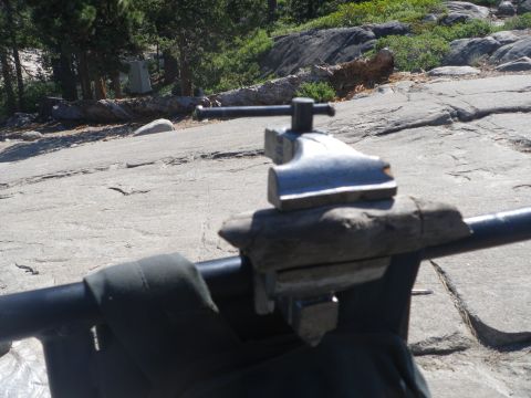 1991 Ford Bronco - A close-up shot shows a bench vise attached to a metal bar in a rocky, outdoor setting.