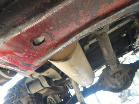 1991 Ford Bronco - Close-up of the undercarriage, showing the exhaust system and drivetrain components.