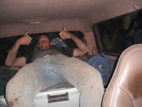 1991 Ford Bronco - A man rests inside a vehicle, giving a thumbs up with both hands.