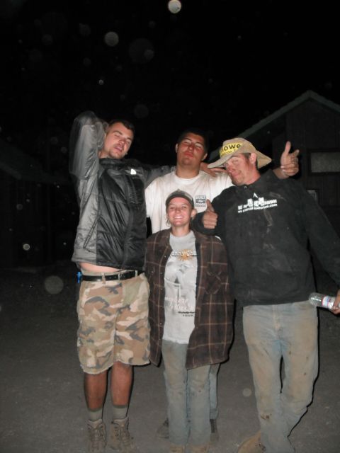 1991 Ford Bronco - A group of friends gathered outdoors at night, with some wearing casual clothing and hats.