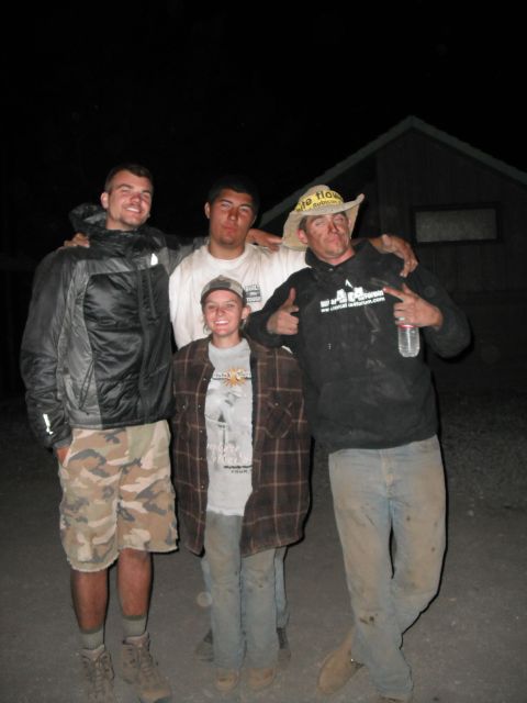1991 Ford Bronco - A group of four individuals pose for a photo outdoors at night, with one person wearing a cowboy hat.