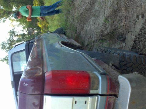 1988 Ford F-150 - This 1987 Ford F-150 is stuck in the mud, with a person observing the situation.
