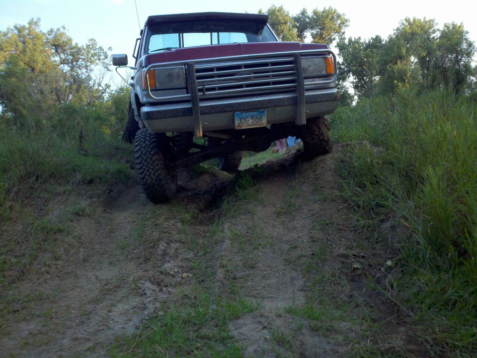 Red 1988 Ford F-150 on a dirt hill