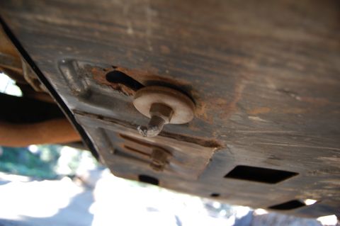 1993 Jeep Wrangler - Close-up view of the undercarriage of a vehicle, showing a bolt and washer on a metal plate.