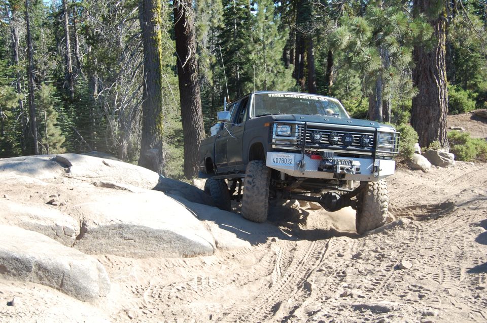 Ford F-Series pickup truck on a rocky trail, front bumper has a winch and license plate 4D78032