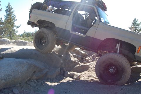 1993 Jeep Wrangler - Modified off-road vehicle navigates a rocky trail with extreme articulation.