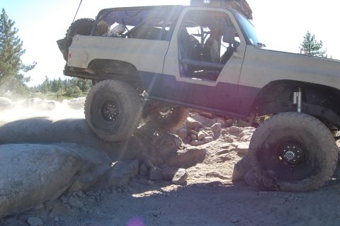 1993 Jeep Wrangler - Modified off-road vehicle tackling a challenging rock crawling course.