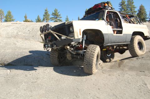 1993 Jeep Wrangler - Modified SUV navigates a rocky trail with its front end angled towards the viewer.