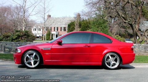 1998 Ford Crown Victoria - Side profile of a red coupe with custom wheels parked on a street.