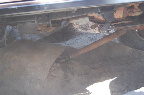 1993 Jeep Wrangler - Undercarriage detail with a rock obscuring part of the drivetrain.