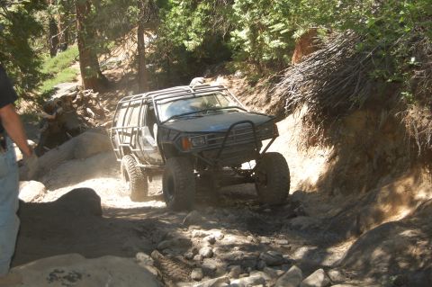 1993 Jeep Wrangler - This heavily modified off-road vehicle navigates a challenging, rocky terrain.