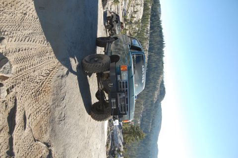 1993 Jeep Wrangler - This modified SUV navigates a challenging rocky trail, with another vehicle visible in the background.