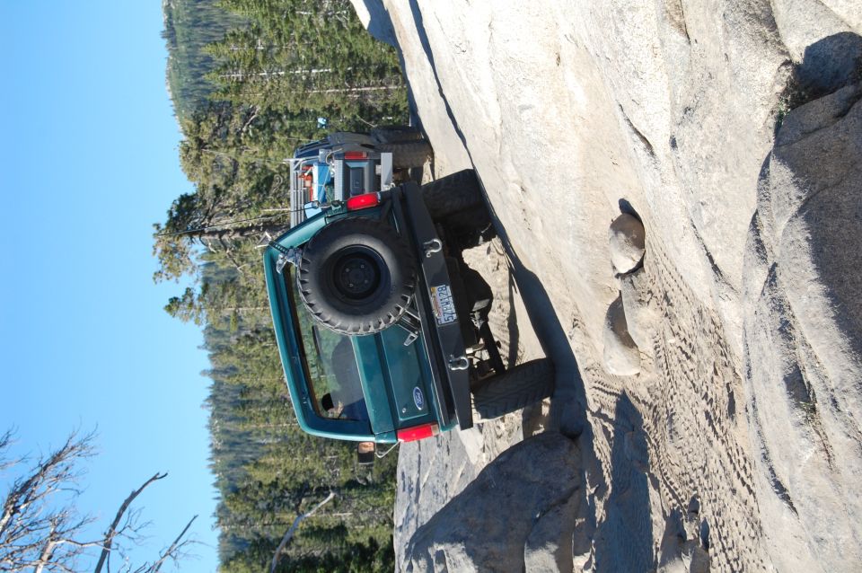 1993 Jeep Wrangler on a rock face, rear view, green