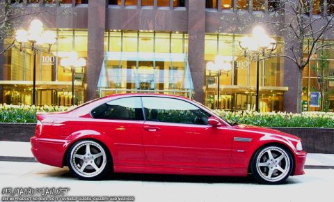 1998 Ford Crown Victoria - Side view of a red coupe with aftermarket wheels parked on a city street.