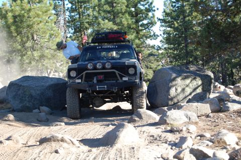 1993 Jeep Wrangler - An off-road vehicle maneuvers through a challenging rocky landscape.