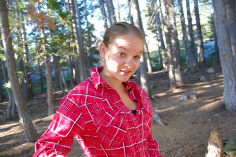 1993 Jeep Wrangler - A young woman in a red plaid shirt poses for a photo in a wooded area.