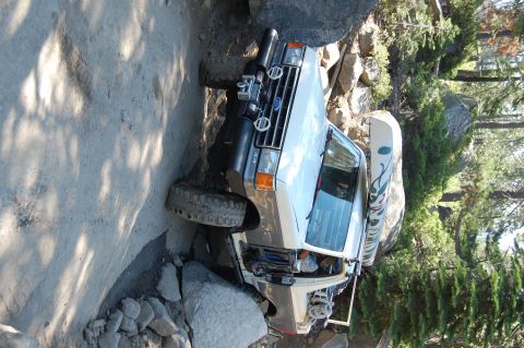 1993 Jeep Wrangler - This Ford Bronco is navigating a difficult, rocky off-road path.