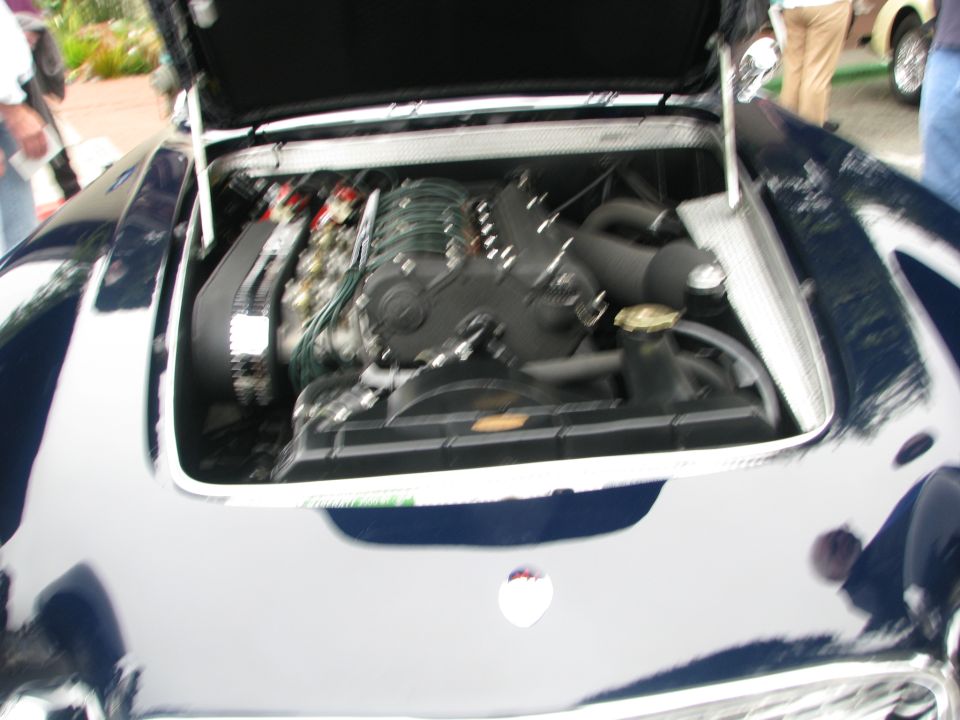 Engine bay of a dark blue car with a V8 engine