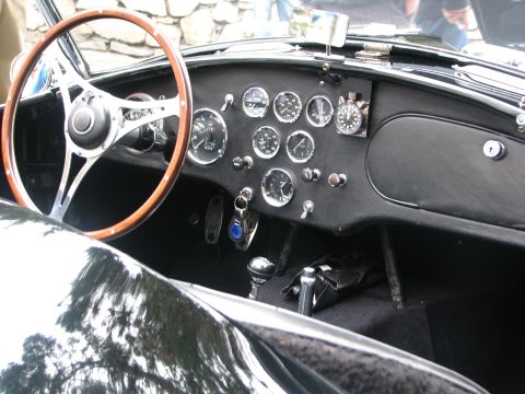 2004 Chrysler PT Cruiser - Dashboard view of a classic car interior, a wood-rimmed steering wheel and numerous gauges.