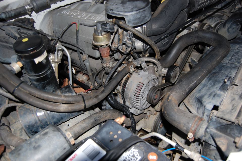 Engine bay showing alternator and hoses. Text reads SUPERMOTORS