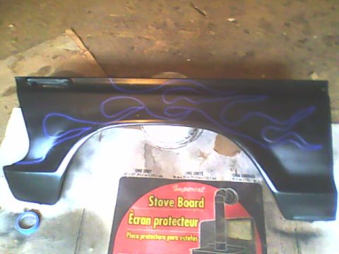 1978 Ford Bronco - A car fender with flame decals is shown, possibly for a Ford Bronco.