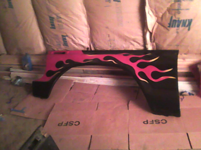 Black fender flare with pink and yellow flame decals, viewed from the side