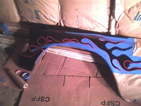 1978 Ford Bronco - Custom flame graphics being applied to a car fender, with masking tape and supplies visible.