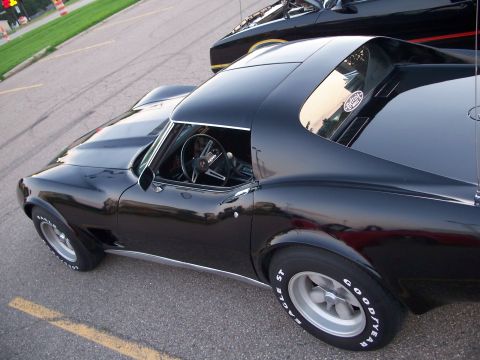 1971 Ford Ranchero - Black 1975 Chevrolet Corvette coupe with racing stripes on hood and side trim.