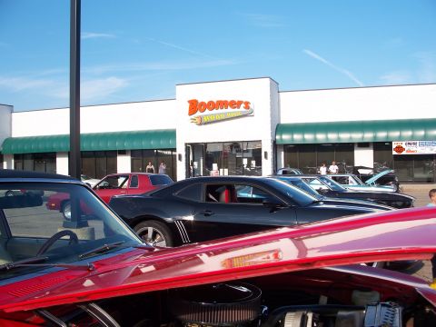 1971 Ford Ranchero - A collection of vehicles are gathered outside a restaurant on a sunny day.