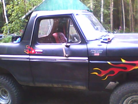 1978 Ford Bronco - This 1978 Ford Bronco features custom flame decals on its side and a red interior.
