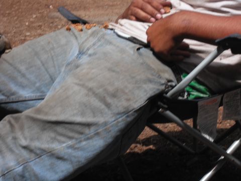 1991 Ford Bronco - A person is seated in a camping chair, with food scattered across their denim jeans.