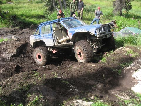 1990 Ford F-250 - This modified Jeep navigates a challenging muddy obstacle course.