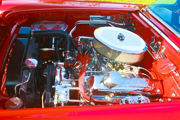 Close-up of a shiny V8 engine with chrome air cleaner and valve covers
