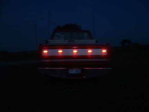 1988 Ford F-150 - Rear view of a 1988 Ford F-150 at night, showing its illuminated tailgate and license plate.