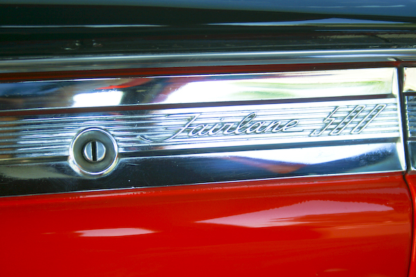Close-up of 1959 Ford Fairlane 500 chrome trim with script and lock cylinder