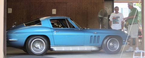 1976 Ford Ranchero - A blue 1963 Chevrolet Corvette Sting Ray coupe is parked indoors with two men standing nearby.