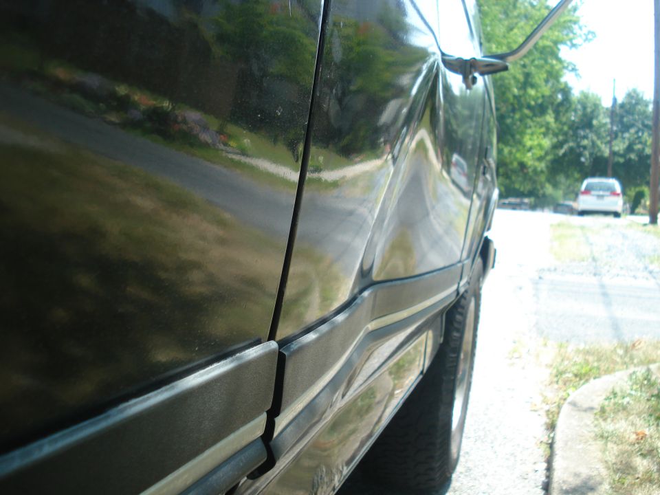 Damaged black SUV side panel