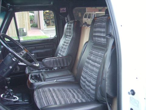 1978 Ford Bronco - Interior view of a 1978 Ford Bronco, with a second vehicle seen through the side window.