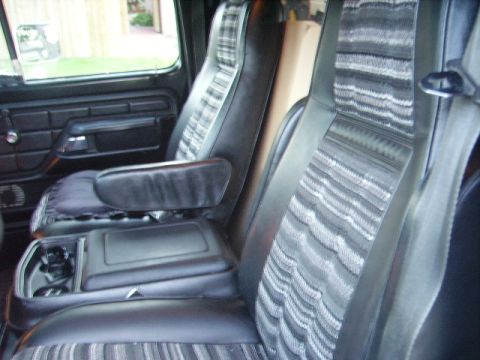1978 Ford Bronco - Interior view of a 1978 Ford Bronco, highlighting the plaid seat fabric and center console.