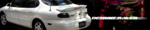 1997 Ford Taurus - White sedan with a spoiler and tinted taillights is shown from the rear.